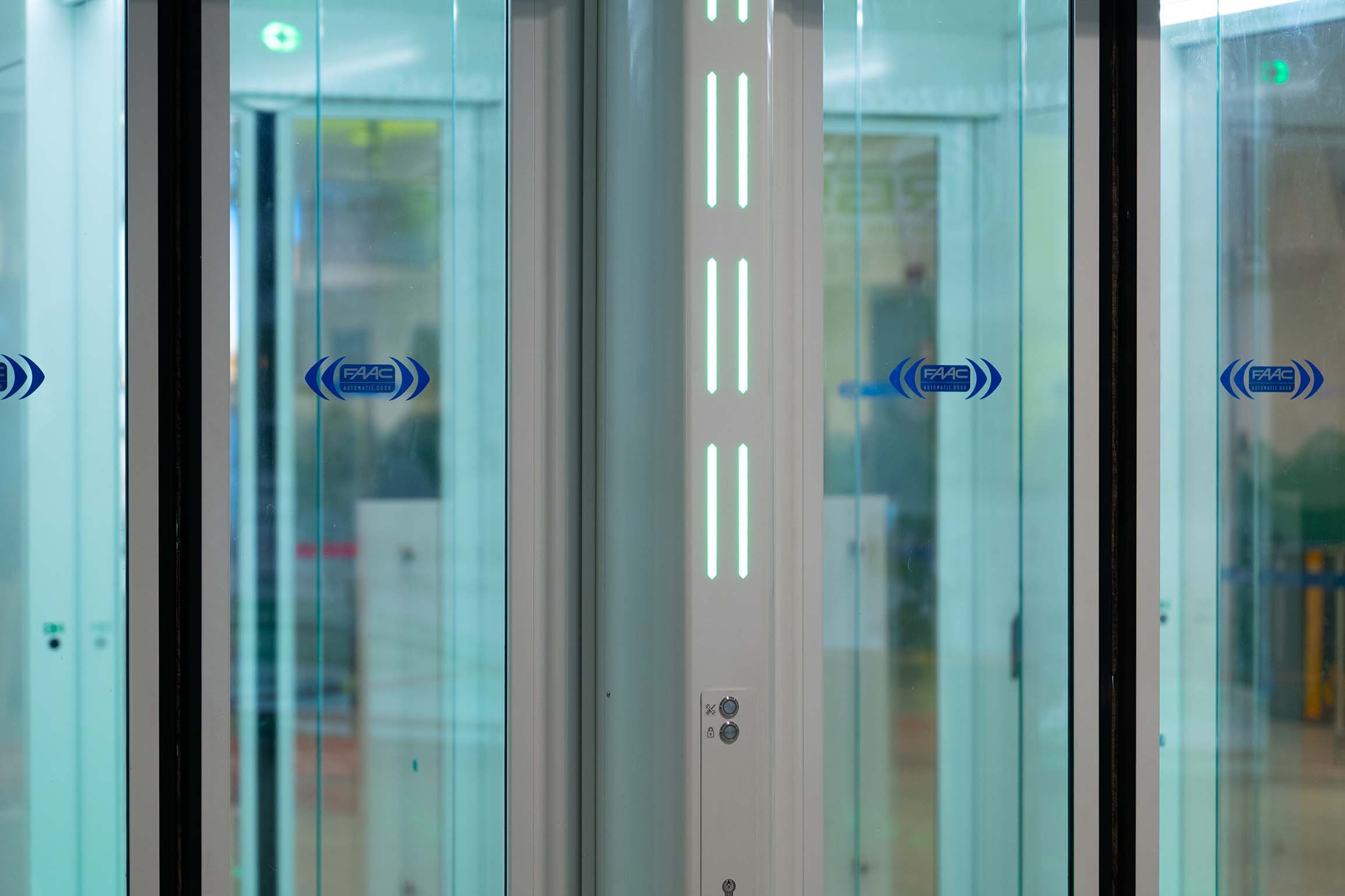 Close-up of the integrated LED signalling and glass panels of a FAAC One-Way Corridor installed at Bologna Airport
