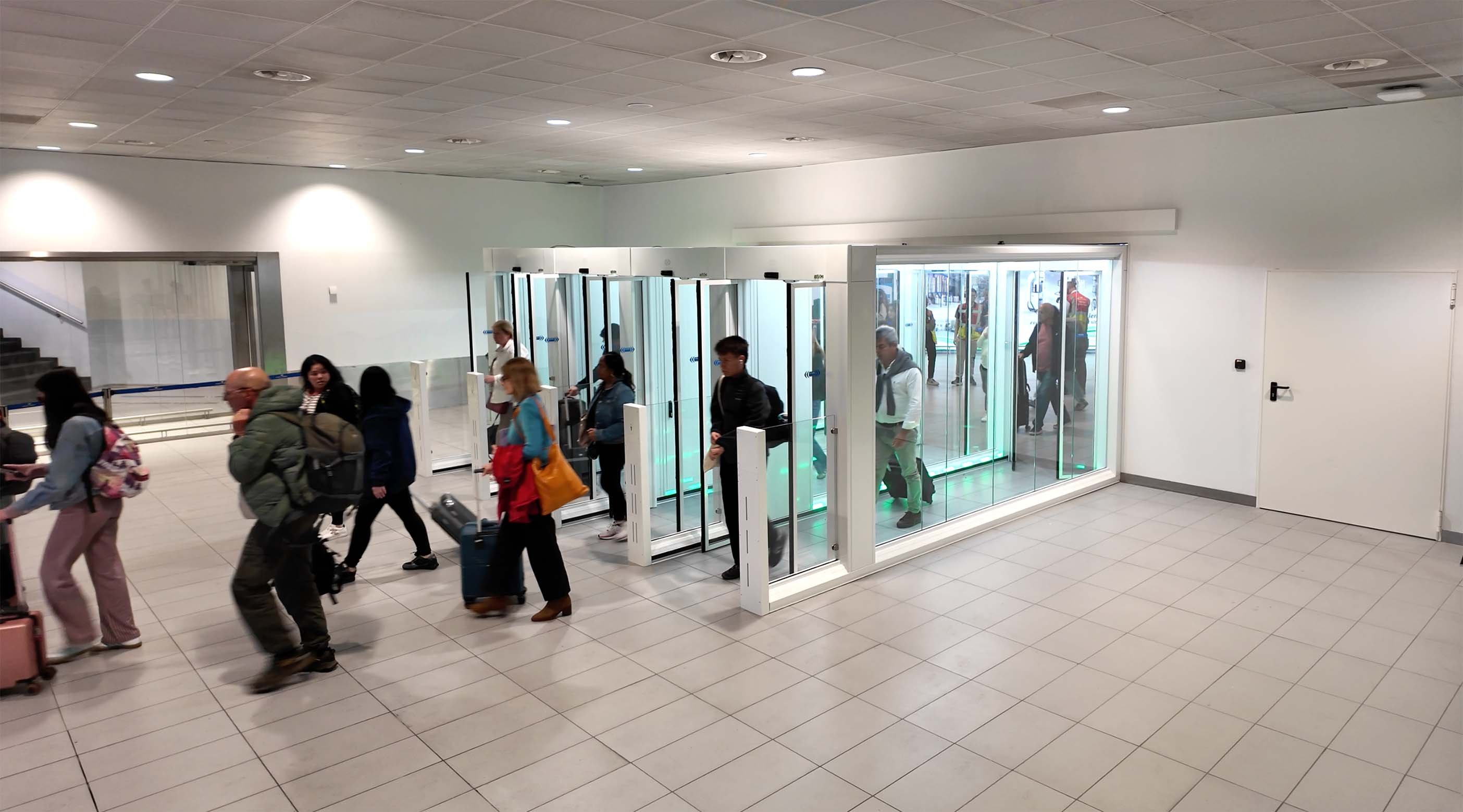 Passengers passing through the FAAC One-Way Corridors in the Schengen Arrivals hall at Bologna Airport